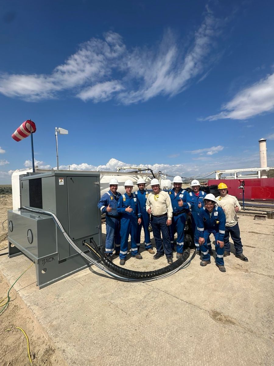 Field crew in front of the BoostFlow container at a wellsite