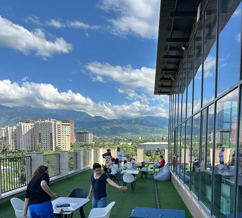 ABSS colleagues on the terrace of the Fortis office, Almaty, with the mountains behind